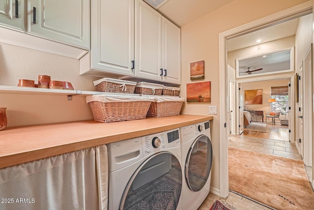 washroom featuring washer and clothes dryer, cabinet space, and ceiling fan