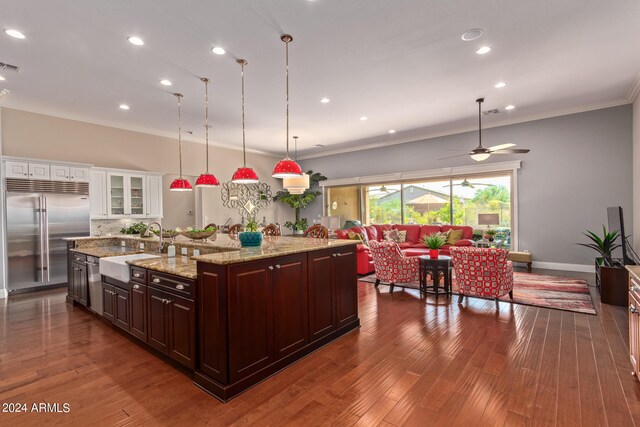 kitchen with a spacious island, sink, dark wood-type flooring, and stainless steel appliances