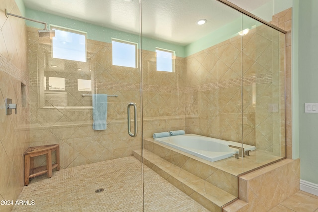 bathroom with separate shower and tub and tile patterned floors