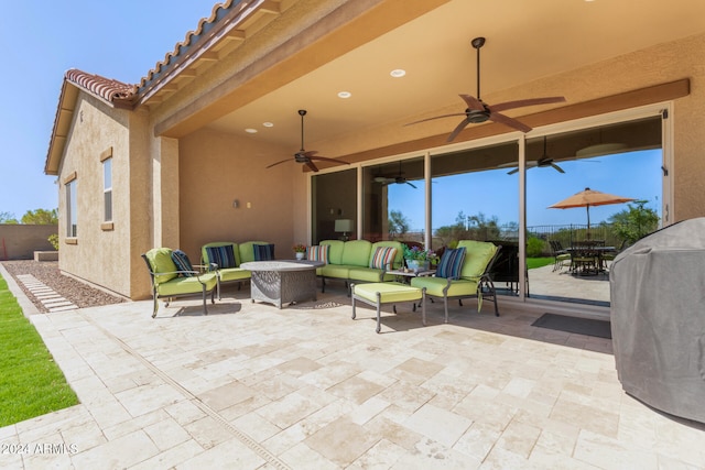 view of patio with area for grilling, ceiling fan, and an outdoor hangout area