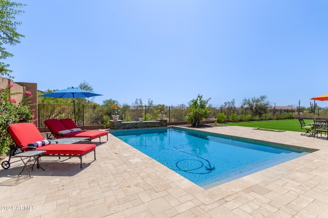 view of swimming pool featuring a yard and a patio area