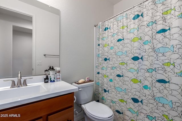 bathroom featuring vanity, curtained shower, and toilet