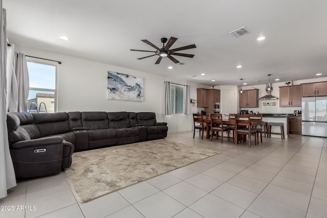 living room with light tile patterned floors and ceiling fan