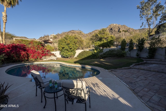 view of swimming pool featuring a mountain view and a patio area