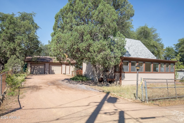 view of front of home with a garage and an outdoor structure