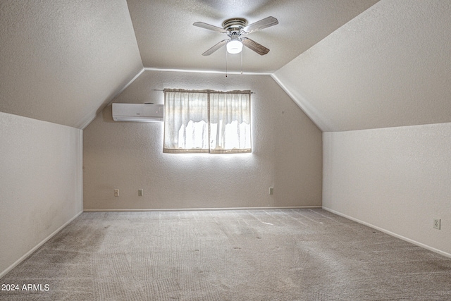 additional living space featuring carpet flooring, vaulted ceiling, a wall mounted air conditioner, and ceiling fan