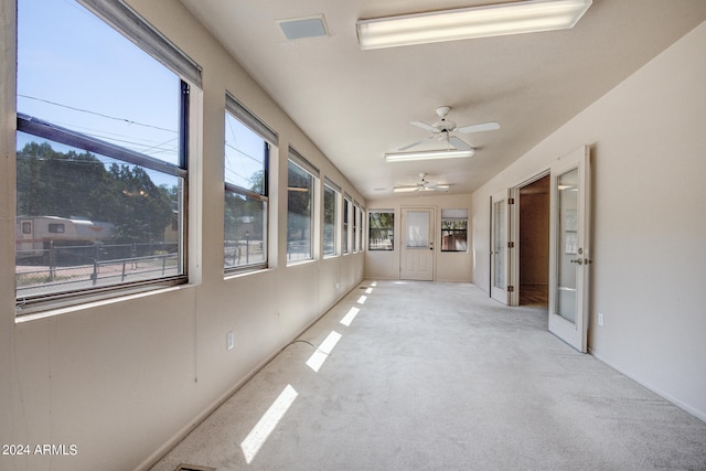 unfurnished sunroom featuring french doors and ceiling fan