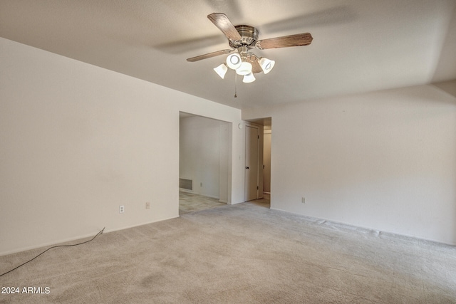 carpeted empty room featuring ceiling fan