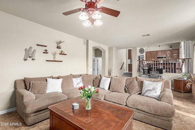 tiled living room with ceiling fan