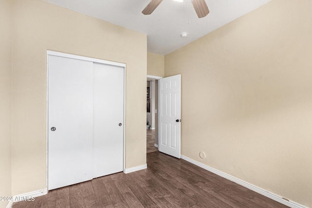 unfurnished bedroom featuring ceiling fan, dark wood-type flooring, and a closet