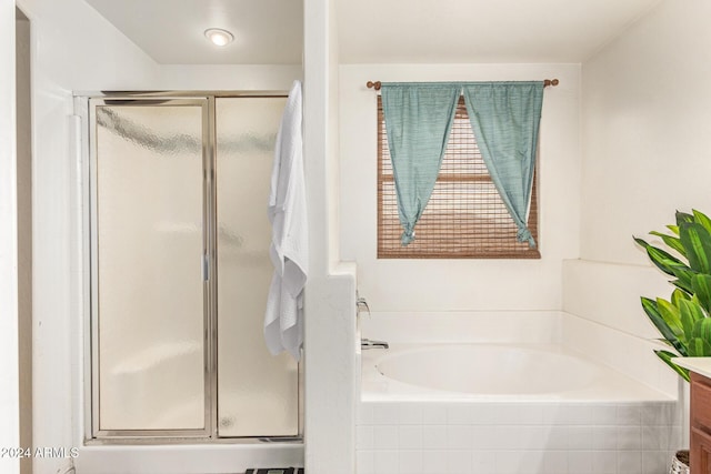 bathroom featuring vanity and shower with separate bathtub