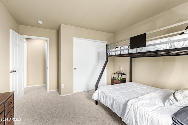 bedroom with carpet and a closet