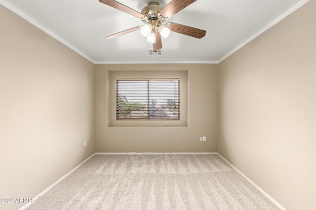 carpeted empty room with ceiling fan and ornamental molding