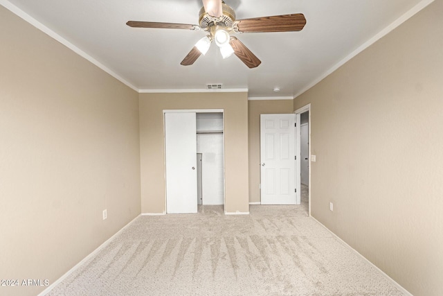 unfurnished bedroom featuring light carpet, a closet, ceiling fan, and ornamental molding