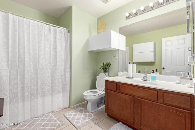 bathroom with tile patterned floors, vanity, and toilet