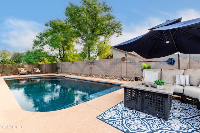 view of swimming pool with a patio area and an outdoor fire pit