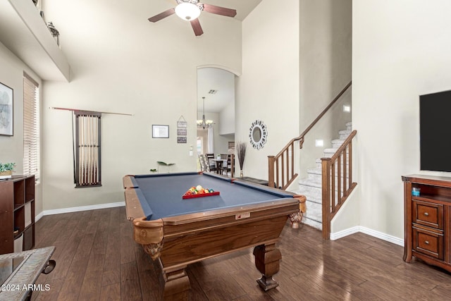 recreation room featuring ceiling fan with notable chandelier, a towering ceiling, dark wood-type flooring, and billiards