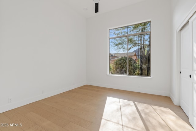 24645 N 117th St, Scottsdale, AZ 85255 - unfurnished bedroom with light wood finished floors, a closet, baseboards, and a ceiling fan