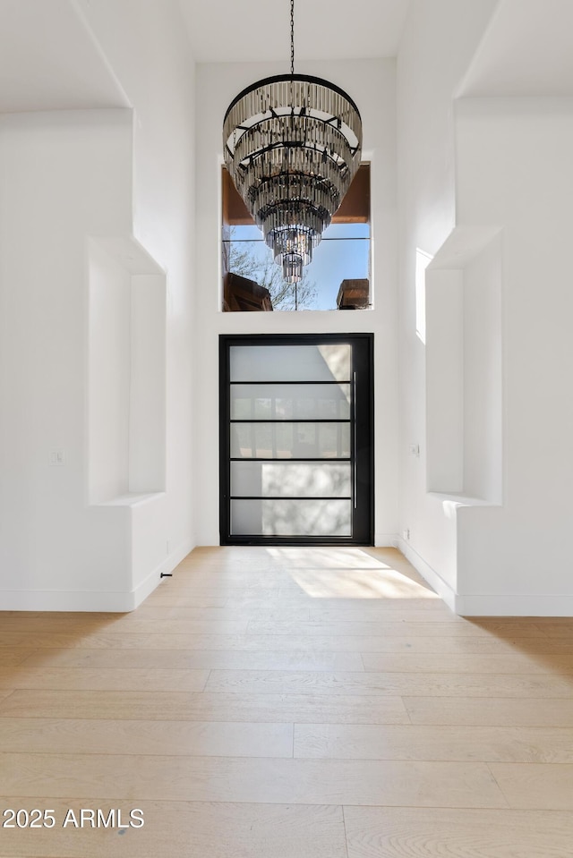 24645 N 117th St, Scottsdale, AZ 85255 - entryway with wood-type flooring, a chandelier, baseboards, and a high ceiling