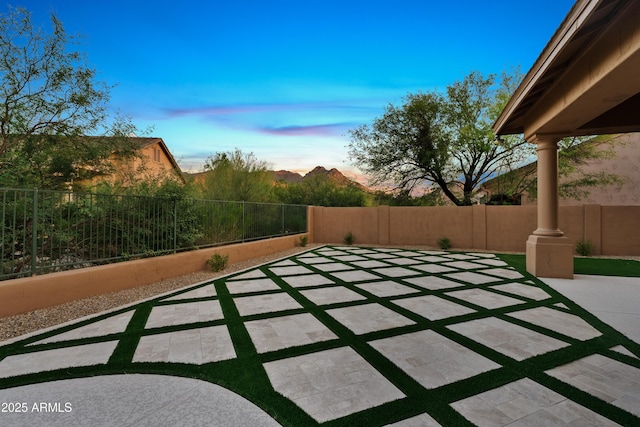 24645 N 117th St, Scottsdale, AZ 85255 - patio terrace at dusk featuring a patio and a fenced backyard