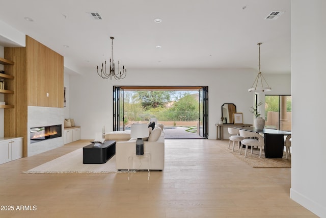 24645 N 117th St, Scottsdale, AZ 85255 - living area featuring light wood-style floors, a fireplace, a chandelier, and recessed lighting