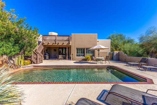 view of swimming pool featuring area for grilling and a patio