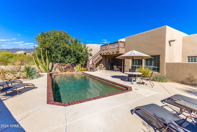 view of pool with a mountain view and a patio area