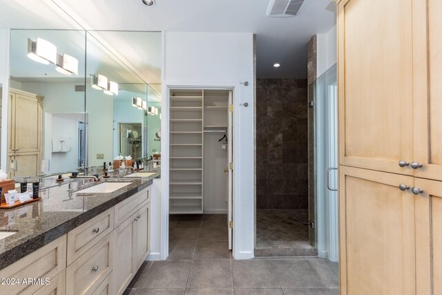 bathroom with tile patterned floors, vanity, and an enclosed shower