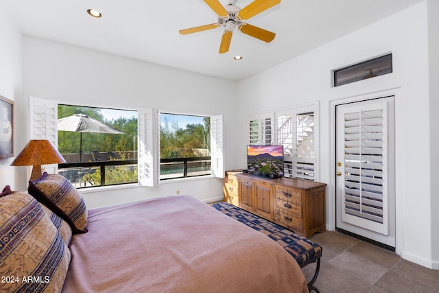 tiled bedroom featuring ceiling fan