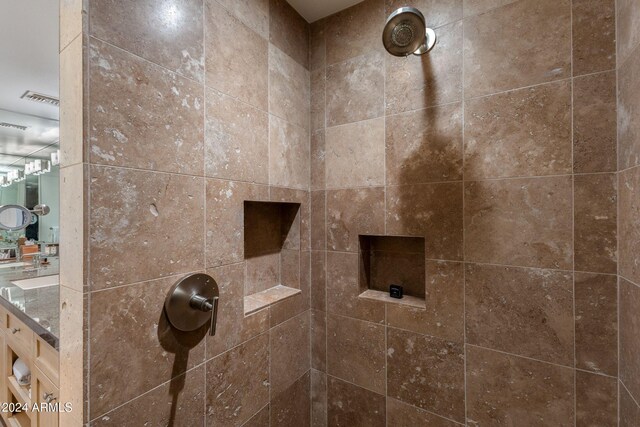 interior details with a tile shower