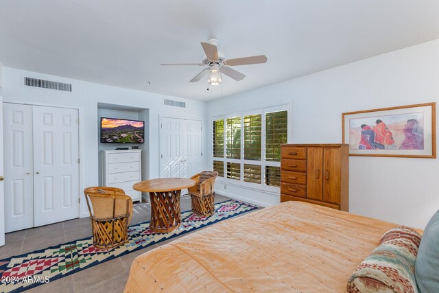 tiled bedroom with ceiling fan