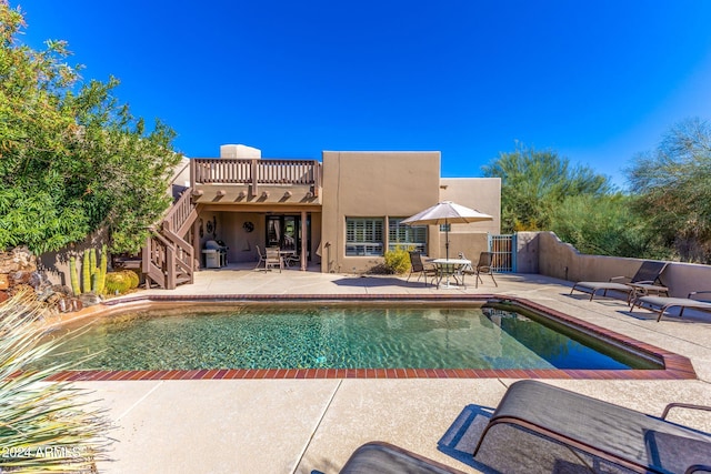 view of pool featuring a patio area and a grill