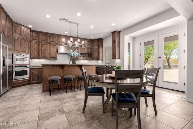 dining room featuring recessed lighting, french doors, and light tile patterned floors