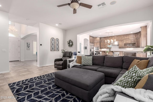 living area featuring arched walkways, a ceiling fan, recessed lighting, and baseboards