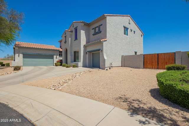 mediterranean / spanish house with stucco siding, concrete driveway, and a tile roof