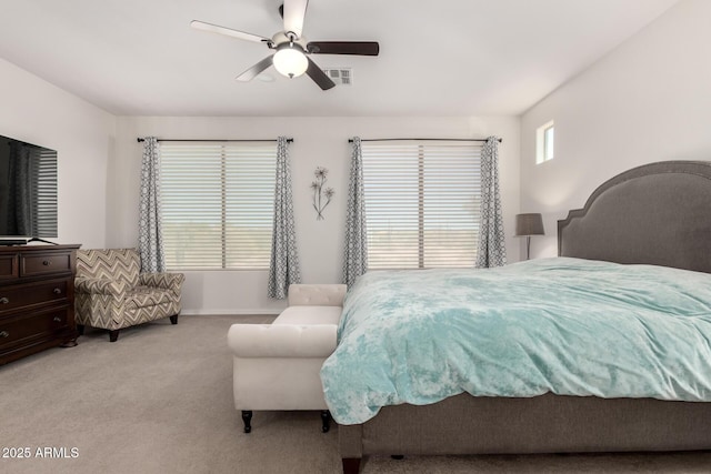 bedroom featuring light carpet, a ceiling fan, and baseboards