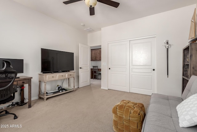 living room featuring ceiling fan, light carpet, and baseboards