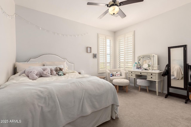 bedroom featuring light carpet, a ceiling fan, and baseboards