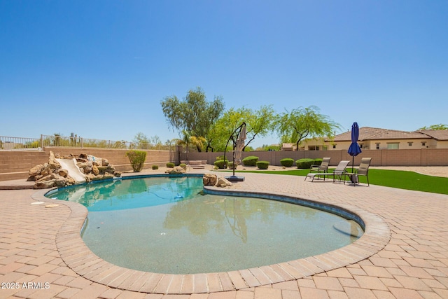 view of pool with a patio and a fenced backyard