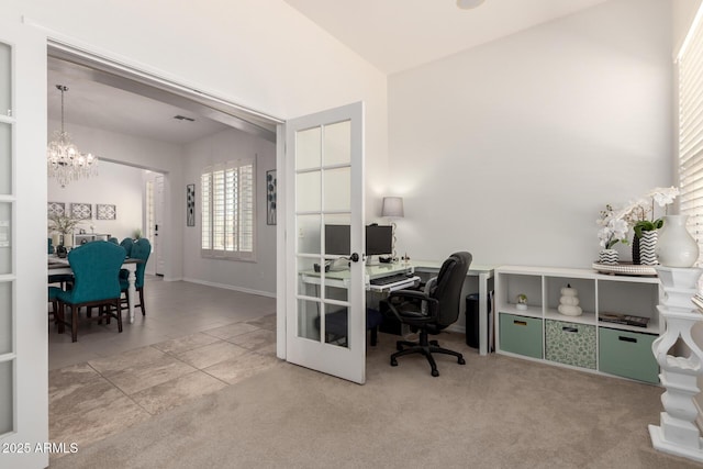 home office with a chandelier and tile patterned flooring