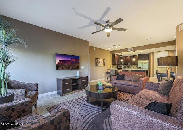 tiled living room featuring track lighting and ceiling fan