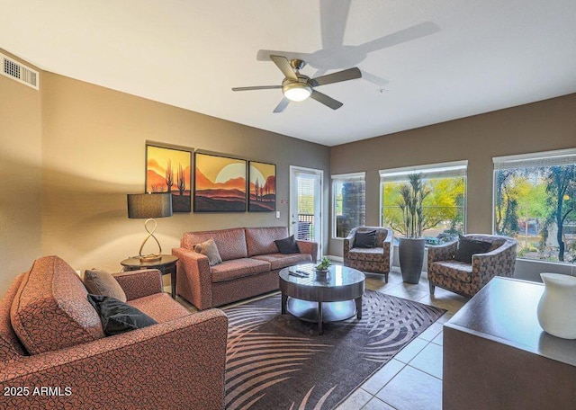 living room featuring ceiling fan and light tile patterned floors