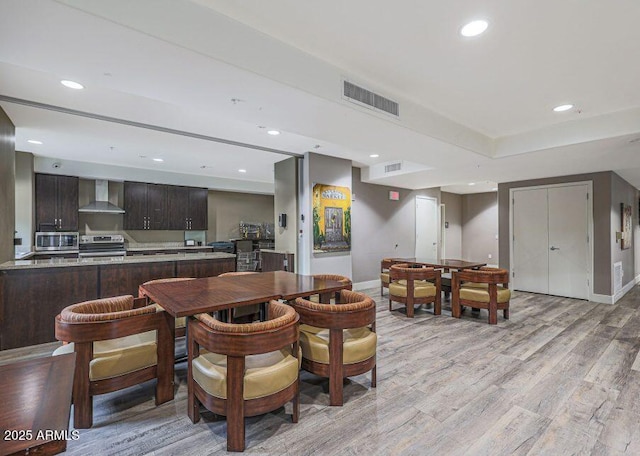 dining space with light wood-type flooring