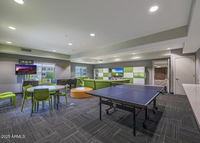 recreation room with dark colored carpet