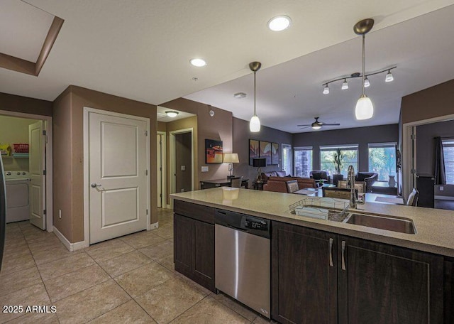 kitchen with pendant lighting, sink, stainless steel dishwasher, ceiling fan, and washer / clothes dryer