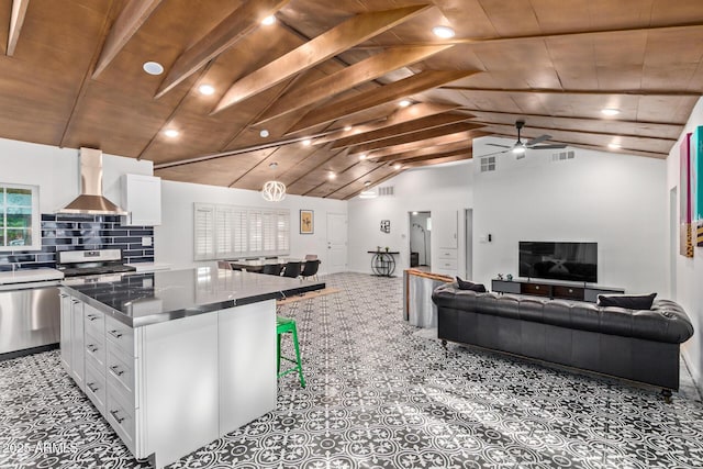 6628 N 2nd Ave, Phoenix, AZ 85013 - kitchen featuring wall chimney range hood, appliances with stainless steel finishes, white cabinets, a center island, and wood ceiling