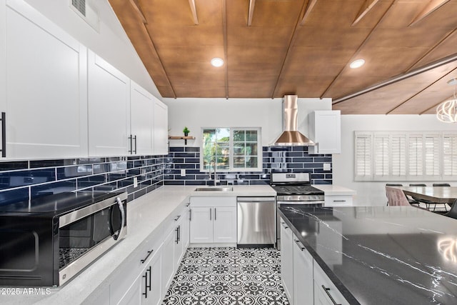6628 N 2nd Ave, Phoenix, AZ 85013 - kitchen with appliances with stainless steel finishes, wall chimney range hood, wood ceiling, a sink, and open shelves
