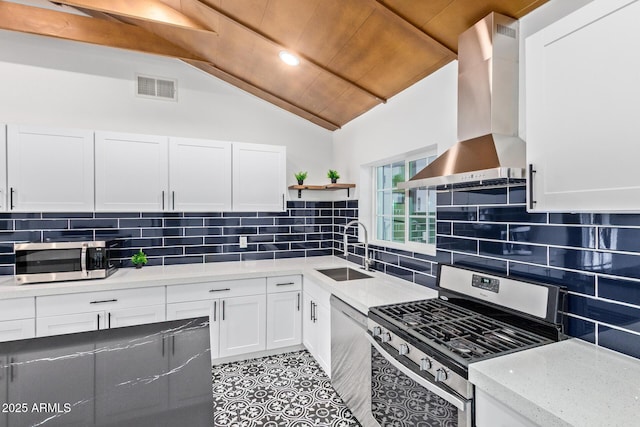 6628 N 2nd Ave, Phoenix, AZ 85013 - kitchen with stainless steel appliances, a sink, open shelves, wall chimney exhaust hood, and white cabinetry