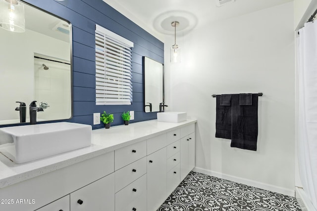 6628 N 2nd Ave, Phoenix, AZ 85013 - bathroom featuring double vanity, baseboards, curtained shower, and tile patterned flooring