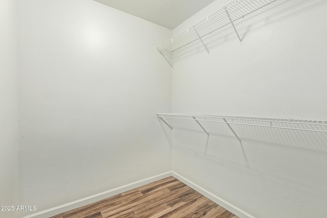 6628 N 2nd Ave, Phoenix, AZ 85013 - walk in closet featuring wood finished floors
